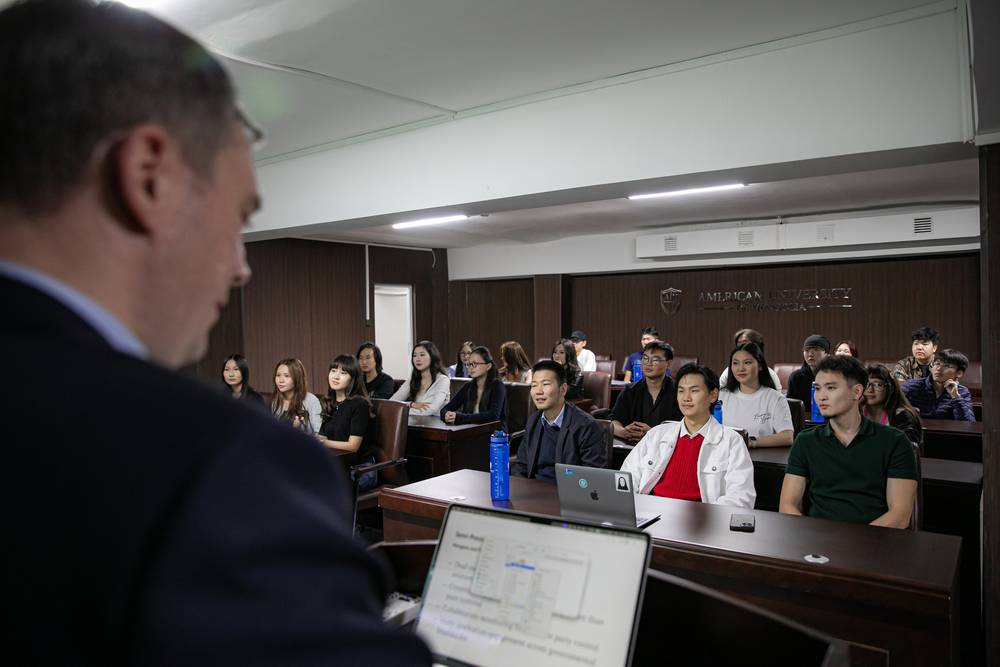 A lecture in progress in a full classroom